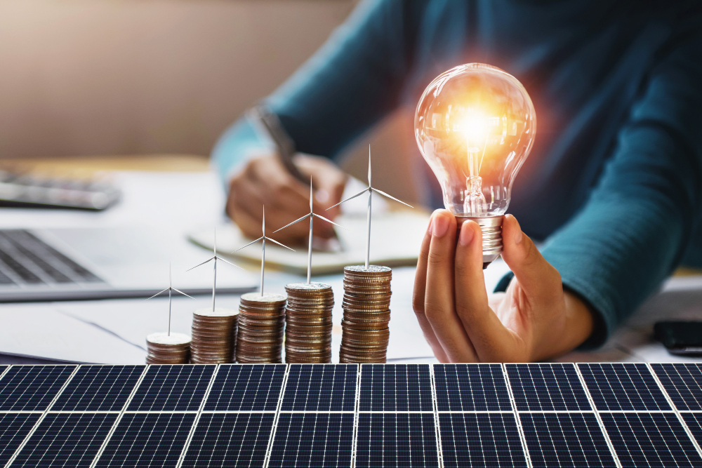 Businesswoman Holding Light Bulb With Turbine on Coins