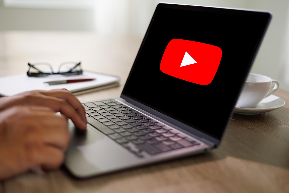  Man Using a Laptop to Watch to YouTube Website