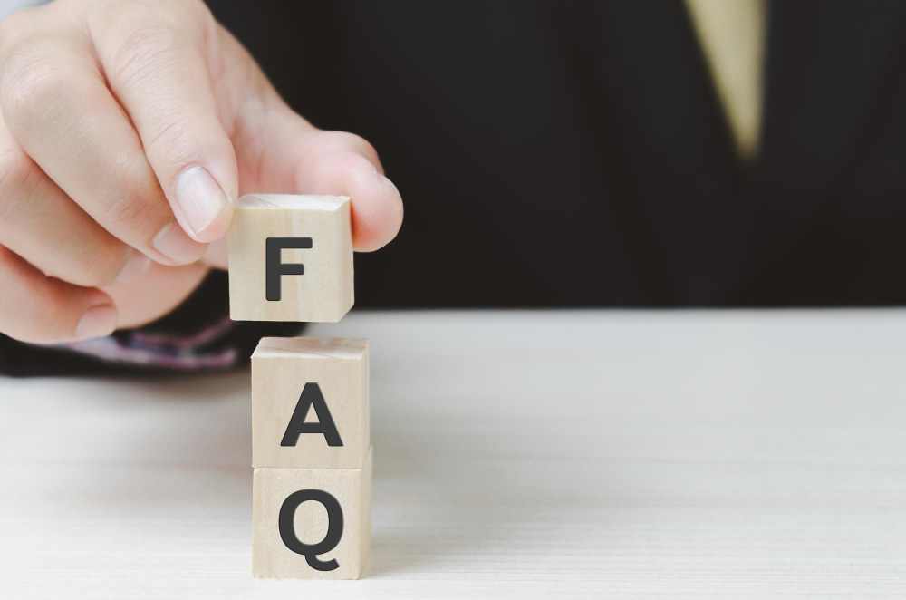 Hand Put Wooden Cubes With FAQ Frequently Asked Questions on Table and Copy Spacebusiness Concepts